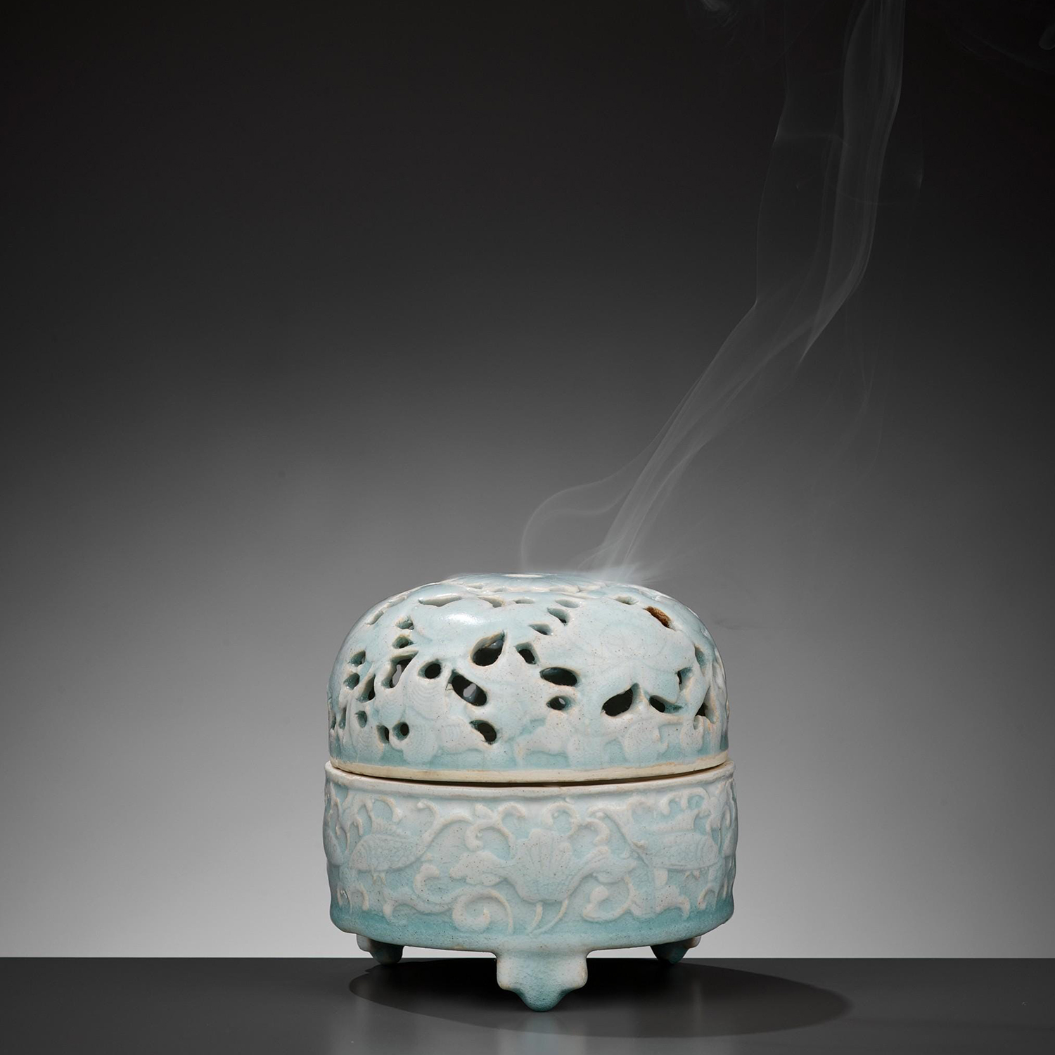 A MOLDED QINGBAI ‘LOTUS POND’ TRIPOD CENSER AND OPENWORK COVER, SONG DYNASTY
